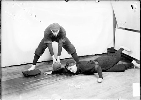 Indoor baseball players, Walter Manning and John Touhy, posing in front of a light colored background in a room - Chicago Daily News, Inc.