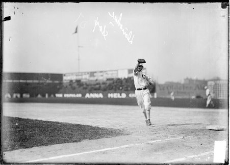 White Sox first baseman Jiggs Donohue, reaching in the air with his gloved right hand to catch a baseball, at South Side Park - Chicago Daily News, Inc.