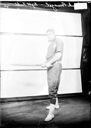Pilsen Turner indoor baseball player Frank Pomazel, holding a bat at waist level standing in front of a light colored backdrop - Chicago Daily News, Inc.