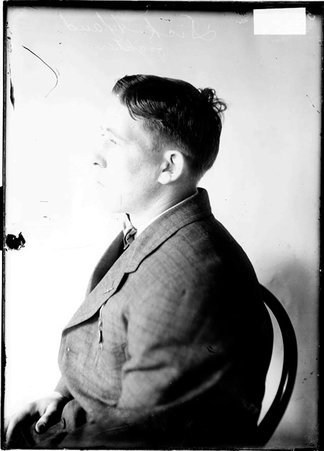 Pugilist, Dick Hyland, sitting in profile against backdrop - Chicago Daily News, Inc.