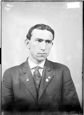 Skater, Morris Wood, sitting in front of a light colored background in a room - Chicago Daily News, Inc.