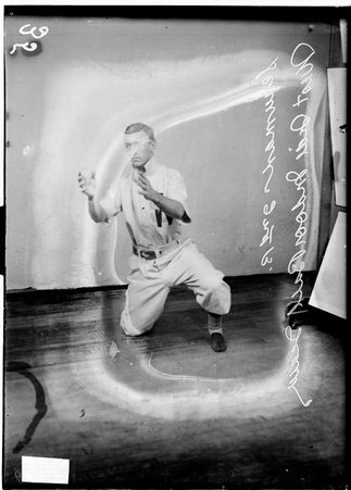 Indoor baseball player, West Side YMCA, Schuman, kneeling on his right knee - Chicago Daily News, Inc.