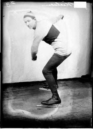 Skater, G. C. Nielson, standing in front of a light colored background in a room - Chicago Daily News, Inc.