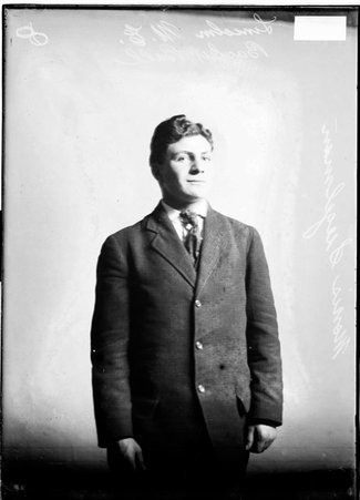 Lincoln M. E. basketball player, Morris Siegleman, standing in front of a light colored background in a room - Chicago Daily News, Inc.