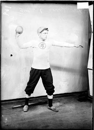 First Methodist Episcopal Church indoor baseball player, George Norris, holding a ball in his hand over his right shoulder in a room - Chicago Daily News, Inc.