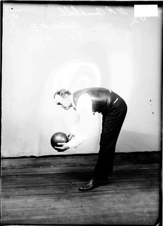 Austin Methodist Episcopal Church bowler, W. R. Campbell, holding a bowling ball in a room - Chicago Daily News, Inc.