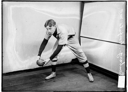 Indoor baseball player, Garfield M. E. Church, A. Sanberg, leaning forward, holding a ball in front of backdrop in room - Chicago Daily News, Inc.