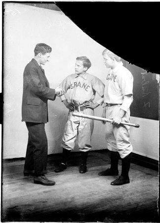 Crane indoor baseball players, F. Smejkal, O. Murdough, and F. Kubat, standing in front of a light colored background in a room - Chicago Daily News, Inc.