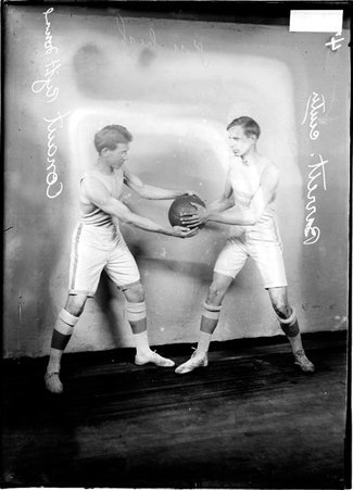 YMCA Comet basketball team players, C. L. Barrett and W. A. Conaut struggling for possession of the ball in a room - Chicago Daily News, Inc.