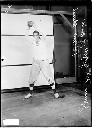 First Methodist Episcopal Church indoor baseball team first baseman James McGregor, holding a ball above his head with both hands - Chicago Daily News, Inc.