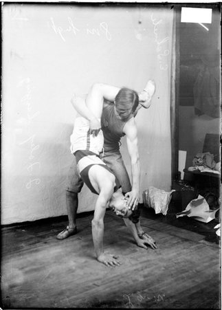 Wrestlers, Lincoln Juniors, E. Schuele, and J. Foley, performing a maneuver on the floor - Chicago Daily News, Inc.