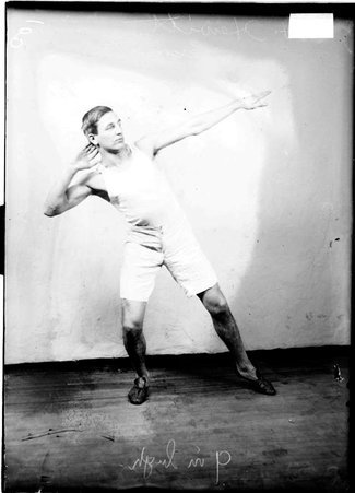 Lexington Ave. Baptist track team athlete, H. Hewitt, in a room, leaning back, bending knees, arm behind head - Chicago Daily News, Inc.