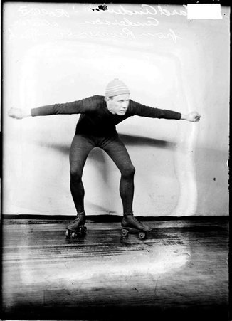 Roller skater Richard Anderson, facing the camera with both arms out to his sides - Chicago Daily News, Inc.