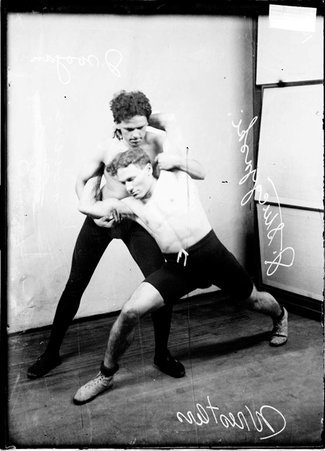 Wrestlers, Wojan standing behind Stuckzynski in an arm lock hold - Chicago Daily News, Inc.