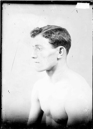 Pugilist, Packey McFarland, side profile from the left, sitting in front of a light colored background in a room - Chicago Daily News, Inc.