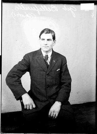 Roller skater George Bellefenille, sitting in a chair in front of a light colored background in a room - Chicago Daily News, Inc.