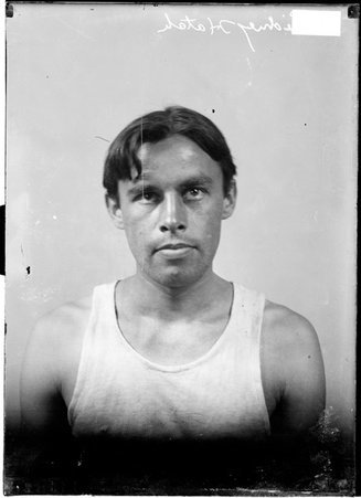 Runner Sidney Hatch, sitting in front of a light colored background looking at the camera in a room - Chicago Daily News, Inc.