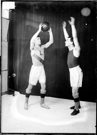 Lake High School basketball players Rosenberg and Gueth, standing in front of a dark backdrop in a room - Chicago Daily News, Inc.