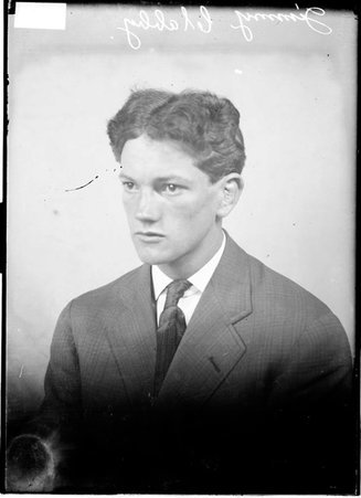 Boxer Jimmy Clabby, from Hammond, Indiana sitting in front of a backdrop - Chicago Daily News, Inc.