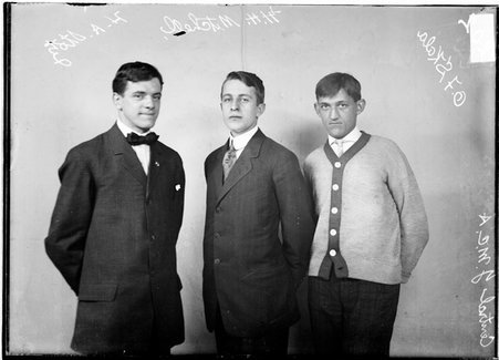Central YMCA indoor baseball players, O. F. Skala, H. H. Mitchell, and H. A. Stolz, standing in front of a backdrop - Chicago Daily News, Inc.