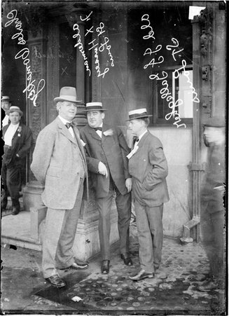 Charles Comiskey standing with aldermen, J. Gallagher and F. Hussey, both of St. Louis, Missouri, near the entrance to a building - Chicago Daily News, Inc.