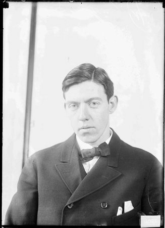 Baseball player C. Mahoney, looking at camera, sitting in front of a light-colored backdrop in a room - Chicago Daily News, Inc.