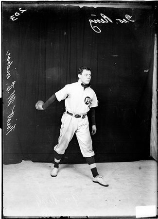 First Methodist Episcopal indoor baseball player George Renz, holding a baseball in his right hand, extended behind him - Chicago Daily News, Inc.