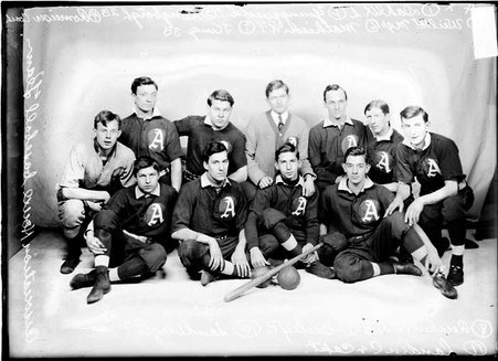 Association House indoor baseball team posing in front of a light-colored backdrop in a room, light exposure - Chicago Daily News, Inc.