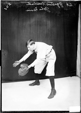 St. Ignatius baseball player John Kevin, leaning forward in a fielding position, holding his hands in front of him - Chicago Daily News, Inc.