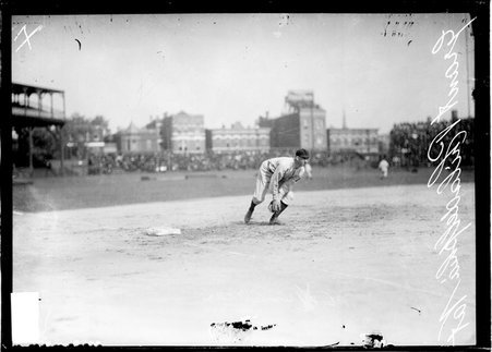 Philadelphia Phillies baseball player Eddie Grant, leaning forward in fielding position, standing near third base at West Side Grounds - Chicago Daily News, Inc.