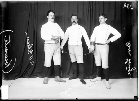 Vorwarts fencers A. H. Glaser, H. Kraft, and Oscar Lange, holding foils, standing in front of a dark backdrop - Chicago Daily News, Inc.