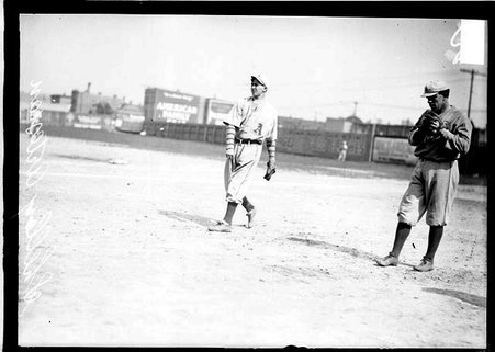 Artesans baseball player, Shelley, following through after throwing a baseball, standing on a baseball field, dark exposure - Chicago Daily News, Inc.
