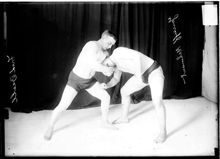 Wrestlers, Fred Beell holding Yussiff Mahout in a front facelock - Chicago Daily News, Inc.