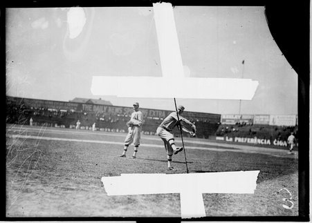 Philadelphia Athletics baseball player Krauss, winding up to throw a baseball, standing on the field at South Side Park - Chicago Daily News, Inc.