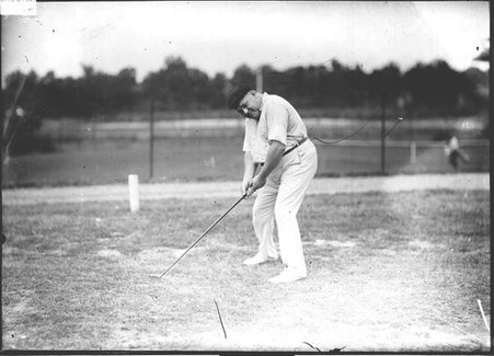 Golfer, H. L. Pound, lining up a shot on the green - Chicago Daily News, Inc.