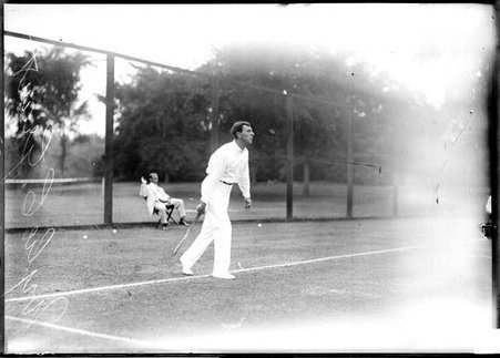 Tennis player, Wylie C. Grant, crossing baseline on tennis court - Chicago Daily News, Inc.