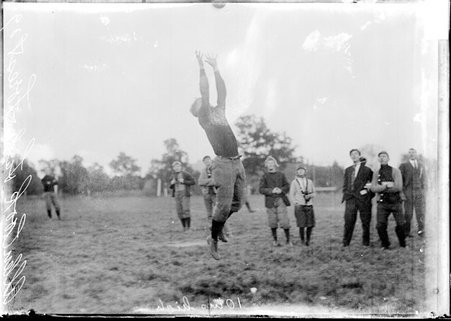 Football player, Al Cook, Lake Forest University, jumping to catch football - Chicago Daily News, Inc.