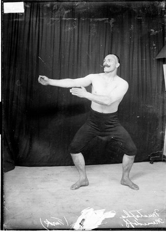 Wrestler, Mustapha (Turk) Memedoff, standing with arms out to the left - Chicago Daily News, Inc.