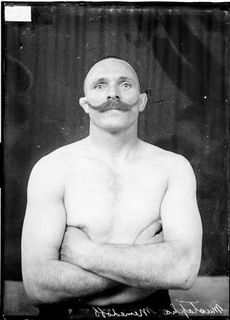 Wrestler, Mustapha (Turk) Memedoff, standing with arms crossed, lighter exposure - Chicago Daily News, Inc.