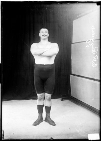 Wrestler, E. Ruggiero, standing with arms crossed - Chicago Daily News, Inc.