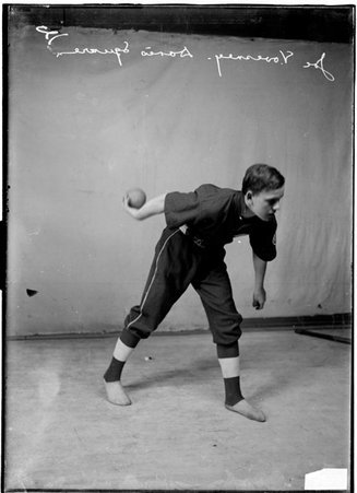 Indoor ball player, Vovesney, Davis Square indoor ball team, bending forward with ball, facing toward right, darker exposure - Chicago Daily News, Inc.