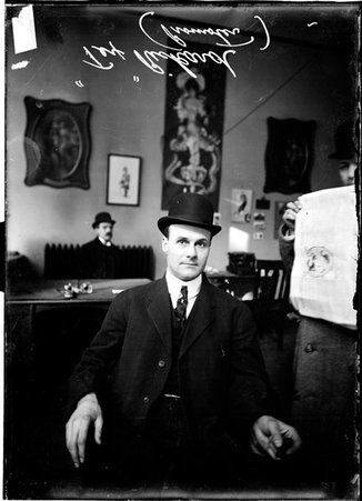 Promoter, Tex Rickard, sitting in an office - Chicago Daily News, Inc.