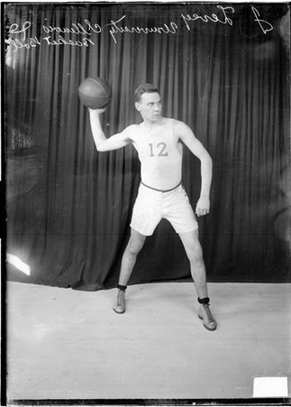 Basketball player, Jack Levey, University of Illinois, holding basketball over right shoulder - Chicago Daily News, Inc.