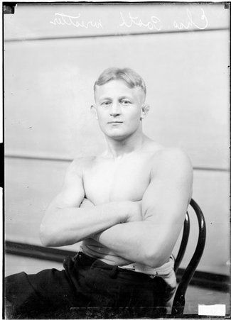 Wrestler, Charles Postl, sitting with arms crossed - Chicago Daily News, Inc.