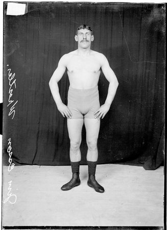 Wrestler, Jim Esson, standing with arms akimbo - Chicago Daily News, Inc.