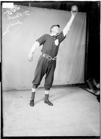 Indoor ball player, T. Pawl, Davis Square team, reaching toward ceiling with ball - Chicago Daily News, Inc.