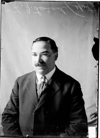 J. L. Leonard, sports, sitting in front of light backdrop - Chicago Daily News, Inc.