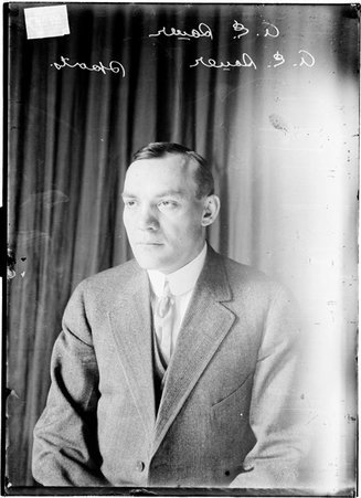 A. E. Sauer, sports, sitting in front of dark backdrop - Chicago Daily News, Inc.