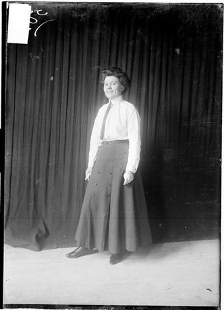 Miss Vera Carby, West Park Institute, sports, standing in front of dark background - Chicago Daily News, Inc.