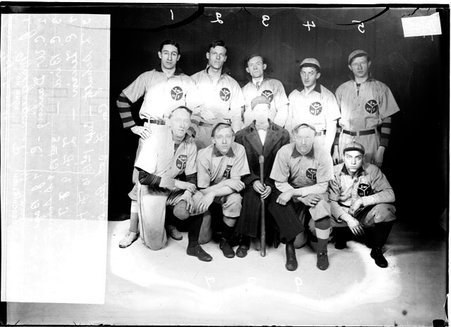 Indoor ball players, C. W. Darling, E. Lewin, S. Schultz, C. Bir, T. Pawl, J. Macgregor, J. Bogs, J. Gorney, and F. Hirsch, 2nd Regiment, posing in front of dark backdrop - Chicago Daily News, Inc.